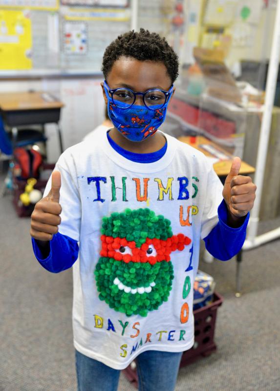 Worcester Prep second- and third-graders designed 100th Day T-shirts to wear to school. Second-grader Darius Jones gives a thumbs-up for being 100 days smarter!